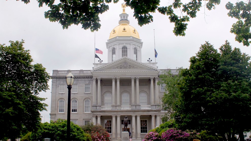 A old grey building with gold on top of it.